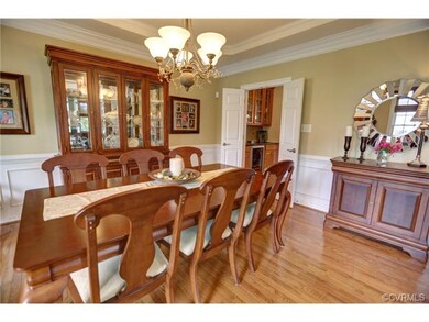 Formal dinning room with tray ceiling connected to