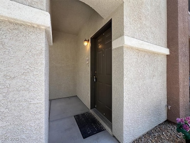 View of exterior entry featuring stucco siding