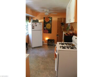 Adjacent to dining, kitchen stretches along rear o