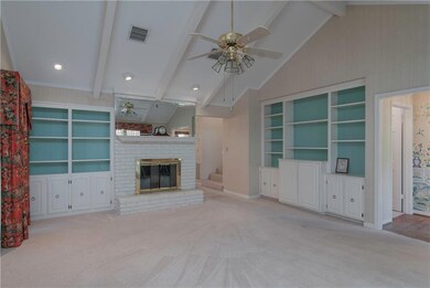 Spacious den features cathedral ceiling, great bui