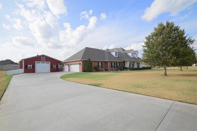 Cape cod house with a front lawn and a garage