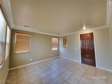 Empty room with ornamental molding and light tile