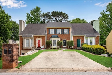 Nestled in a quiet suburban neighborhood with well-maintained landscaping and a shared driveway.