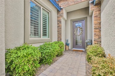 Entrance to property with stone siding and stucco siding
