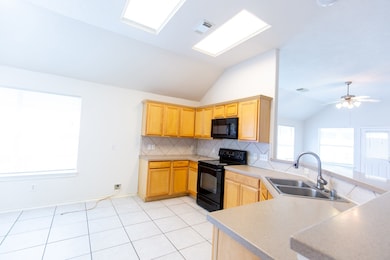 Bright kitchen with vaulted ceilings with plenty o