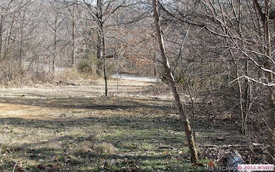 View of property out to county paved road in front