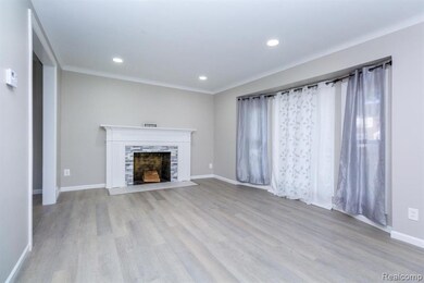 Unfurnished living room featuring light wood-style floors, recessed lighting, and a fireplace with flush hearth