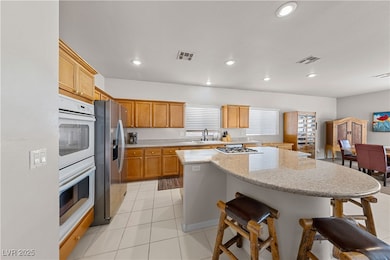 The large granite island in the kitchen offers ple
