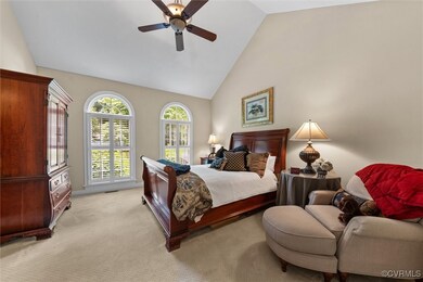Bedroom with light carpet, a ceiling fan, and high