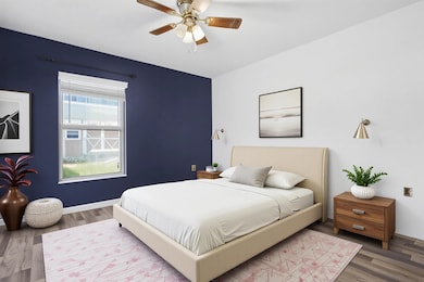 Bedroom featuring wood finished floors and ceiling fan