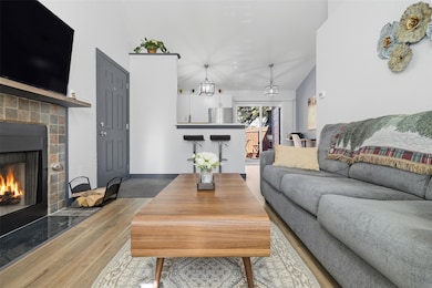 Living area with a fireplace and lofted ceiling