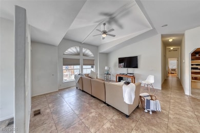 Living room with ceiling fan, light tile patterned