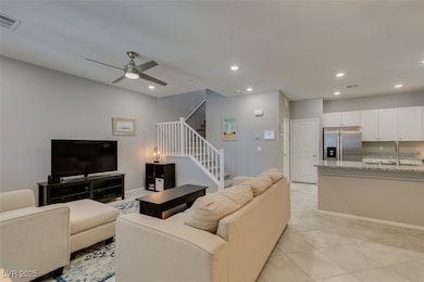 Living room featuring stairway, recessed lighting,