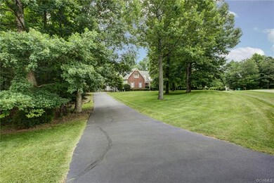 Paved driveway leading to 3-car garage with car li