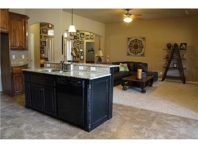 Kitchen. Distressed black kitchen island adds char
