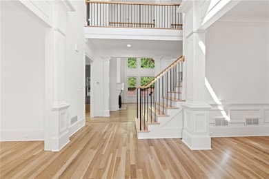 Entrance foyer featuring a towering ceiling, decor