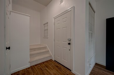 The inviting foyer leads to the living area, a con