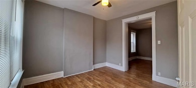Spare room featuring wood finished floors and a ceiling fan