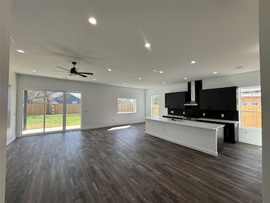 Unfurnished living room with a sink, dark wood-st