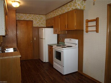 Kitchen is clean and overlooks the back yard.