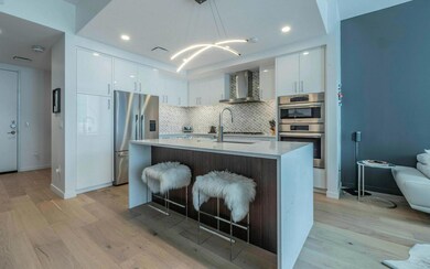 Kitchen featuring stainless steel appliances, wal