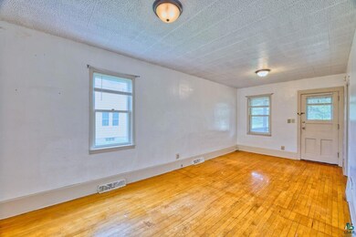 Unfurnished room with hardwood / wood-style flooring