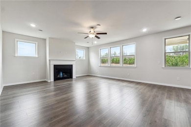 Unfurnished living room featuring baseboards, ceil