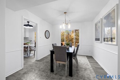 Dining room featuring wood finished floors and a chandelier