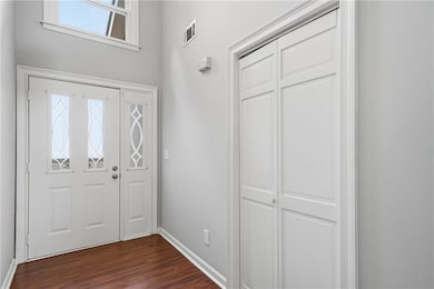 Entrance foyer featuring dark wood finished floors and baseboards