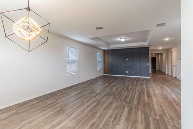 Unfurnished living room featuring wood finished fl