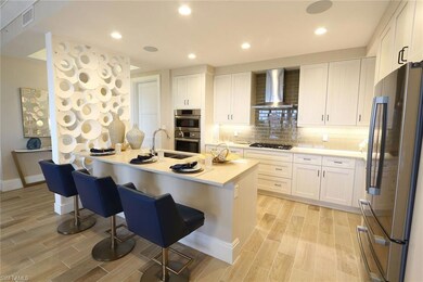 Kitchen with visible vents, a breakfast bar, a sin