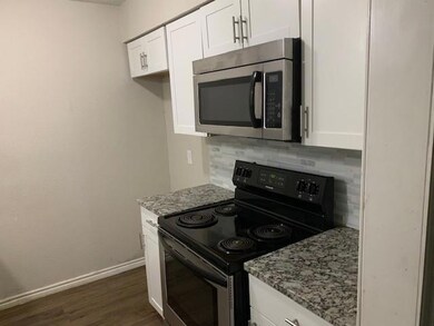 Kitchen featuring backsplash, light stone counters