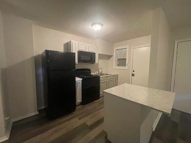 Kitchen with dark hardwood / wood-style flooring, 