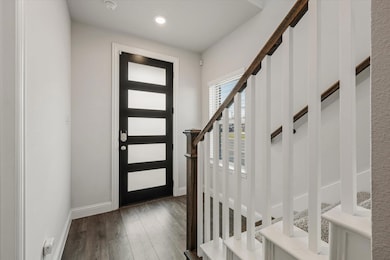 Entrance foyer with dark hardwood / wood-style flo