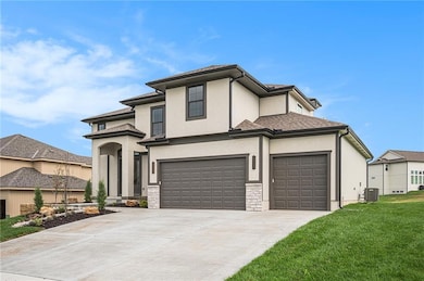 Prairie-style home featuring concrete driveway, stucco siding, an attached garage, a front yard, and roof with shingles