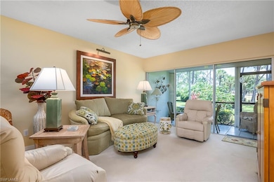 Living room featuring ceiling fan and carpet floor