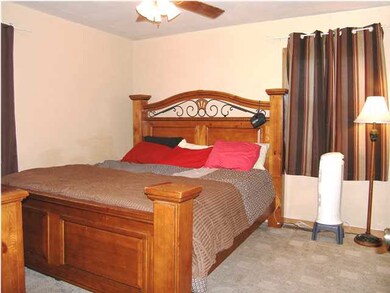 The master bedroom with ceiling fan with light.