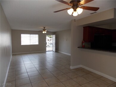 Living room with tile floors, baseboards, and ceil