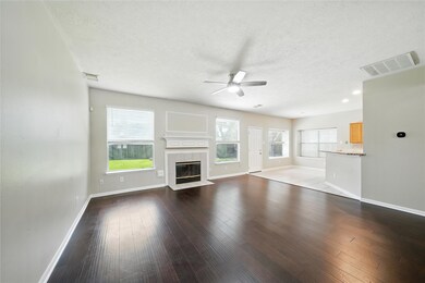 Bright and spacious living area with dark hardwood