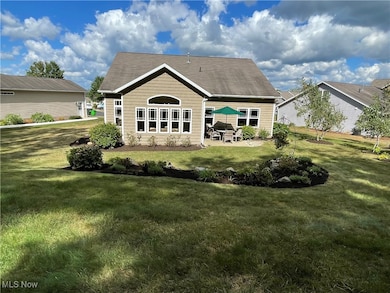 Back of property with a patio area and a yard