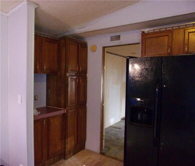 Refrigerator with icemaker, new vented hood, stainless steel sink.