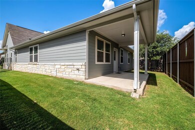 Rear view of house featuring a fenced backyard, a