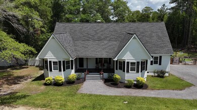 Victorian-style house featuring a sunroom and a shingled roof