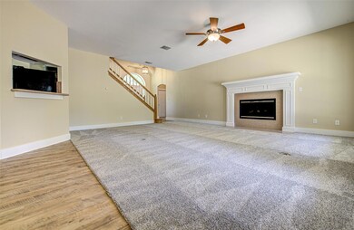 Unfurnished living room featuring a ceiling fan, 