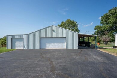 Garage featuring a carport
