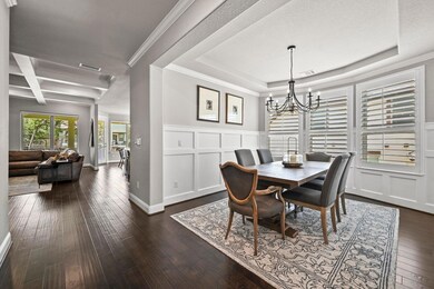 Dining room featuring a chandelier, dark wood fin