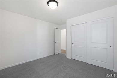Unfurnished bedroom with carpet flooring and a closet