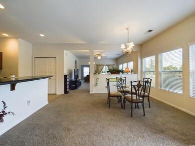 Dining space featuring carpet floors and ceiling f