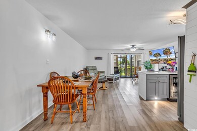 Dining room featuring wine cooler, light wood-style flooring, and ceiling fan