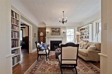 The cozy library has 3 walls of...